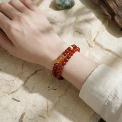 Double-loop Bing Yang Fire crystal jewelry styled on a woman's wrist for energetic empowerment.
