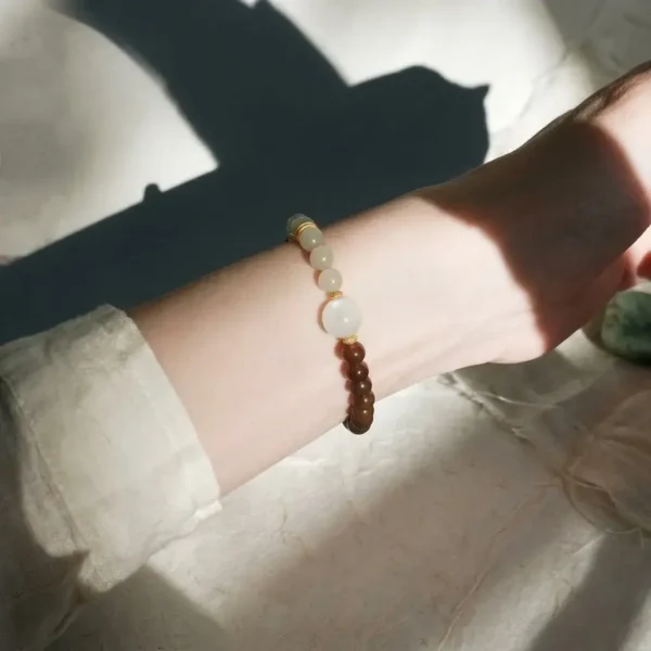 Sophisticated single-loop Ji Yin Earth balancing bracelet worn on a woman's wrist.