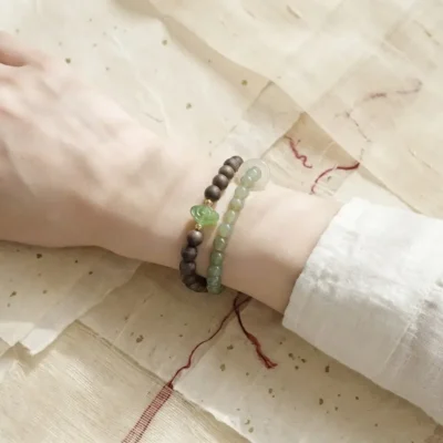 Premium double-loop Jia Yang Wood crystal bracelet styled on the wrist to establish personal rules and aura.