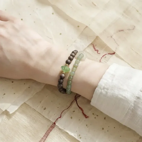 Premium double-loop Jia Yang Wood crystal bracelet styled on the wrist to establish personal rules and aura.