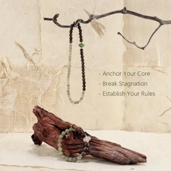 Jia Wood energy bracelet displayed on a natural branch, designed to anchor your core and break stagnation.