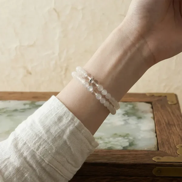 Double-loop Xin Yin Metal crystal bracelet worn on the wrist, highlighting self-improvement and grace.