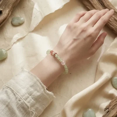 Delicate single-loop Yi Yin Wood healing bracelet worn on the wrist.